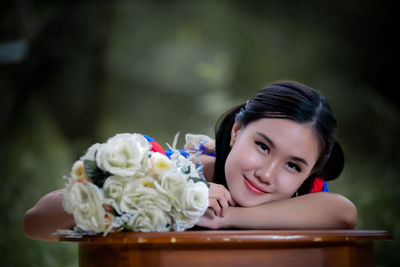 Portrait of young woman with flowers