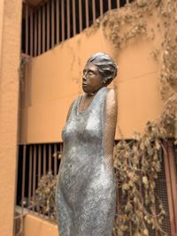 Low angle view of buddha statue against building