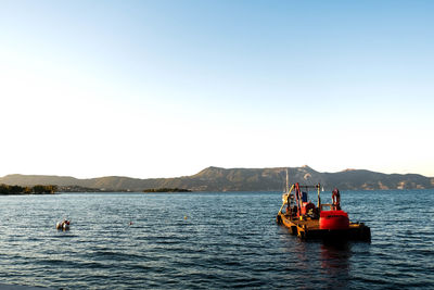 Boat in sea against clear sky