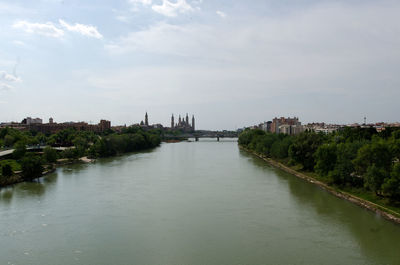 River amidst buildings against sky