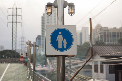 Information sign on pole at bridge