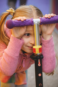 Rear view of woman holding toy