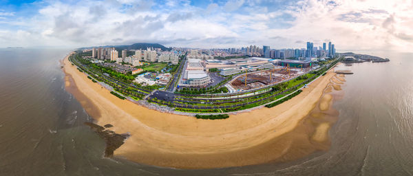 High angle view of buildings against cloudy sky