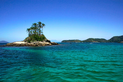 Scenic view of sea against clear blue sky