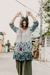 Midsection of woman standing against wall