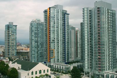 Modern buildings in city against sky