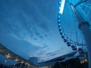 Low angle view of illuminated ferris wheel against sky