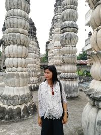 Woman standing against built structure