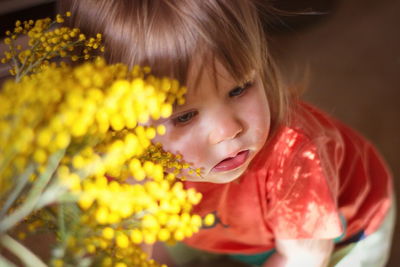 Close-up portrait of a girl with red flower