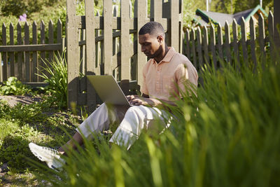 Man with laptop in garden