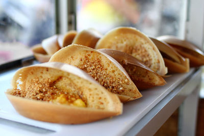 Traditional malaysian street food apam balik - thick soft pancake with peanuts, bananas.