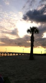 Scenic view of sea against cloudy sky at sunset