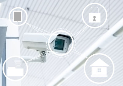 Digital composite image of security camera and various symbols