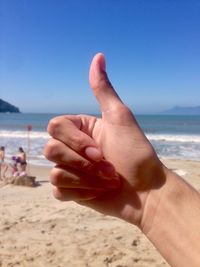 Cropped image of hand doing thumbs up