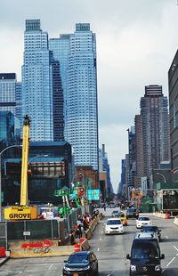 View of city street and buildings against sky