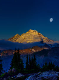 Scenic view of snowcapped mountains against blue sky