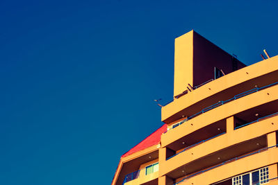 Low angle view of built structure against clear blue sky