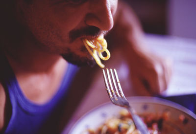 Close-up of man eating food