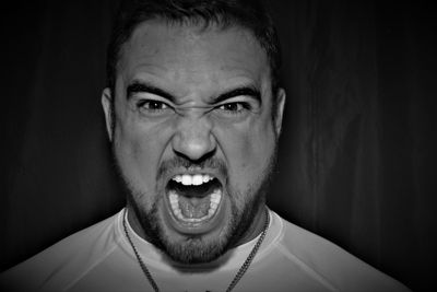 Close-up of man shouting in darkroom