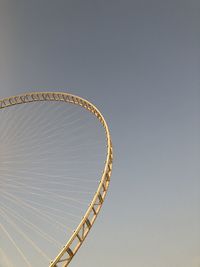 Low angle view of ferris wheel against clear sky