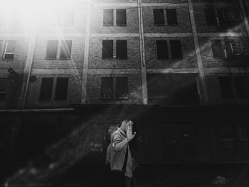 Full length of woman standing in front of building