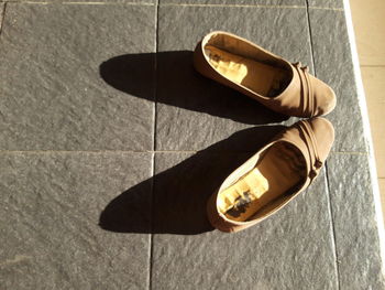 High angle view of shoes on tiled floor