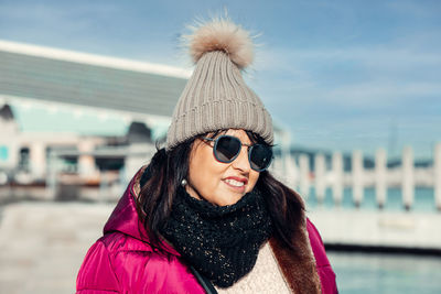 Portrait of young woman wearing sunglasses while standing outdoors