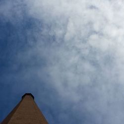 Low angle view of building against cloudy sky