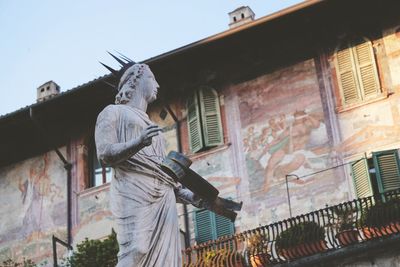 Low angle view of statue against building