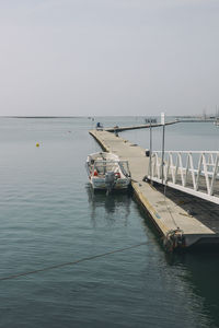 Boats moored on sea against sky