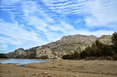 Scenic view of mountains against cloudy sky