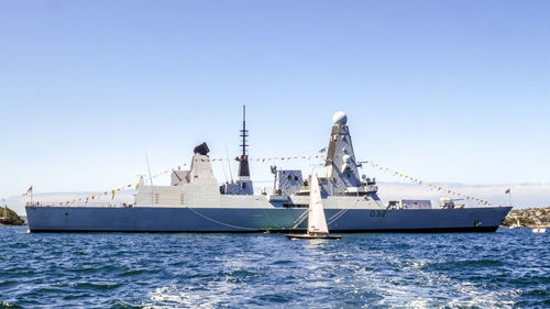 Ship in sea against clear blue sky