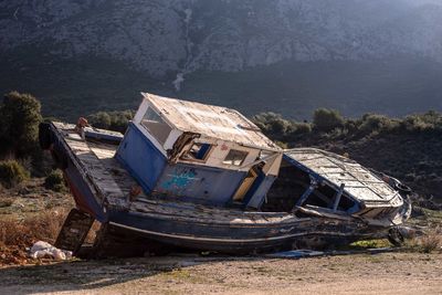 Abandoned boat moored on shore