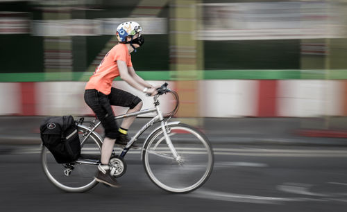 Full length of man with bicycle on road