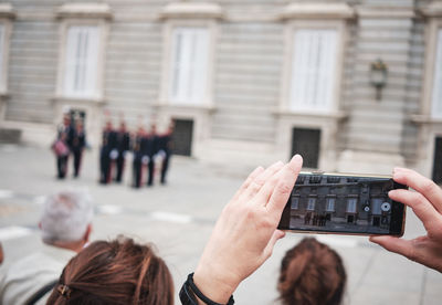 Group of people photographing in city