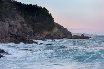 Scenic view of sea and mountains against sky