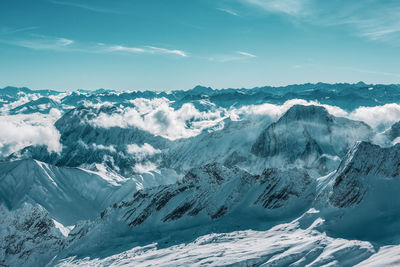 Scenic view of snowcapped mountains against sky