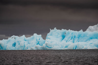 Scenic view of glacier against sky