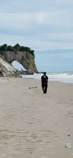 Man on beach against sky