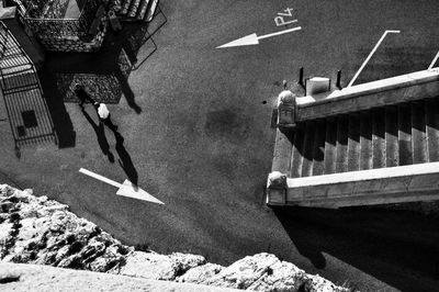 High angle view of men walking on street by steps