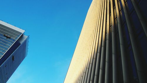 Low angle view of modern building against clear blue sky