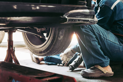 Low section of man standing in car