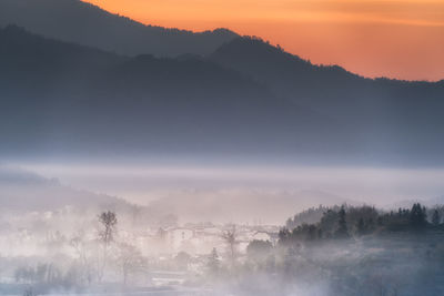 Scenic view of mountains against sky during sunset