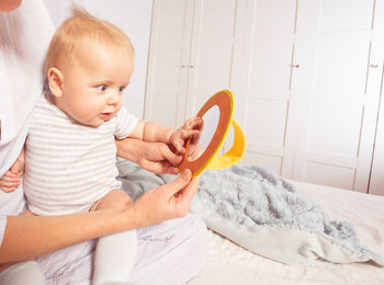 Portrait of cute baby boy sleeping on bed at home