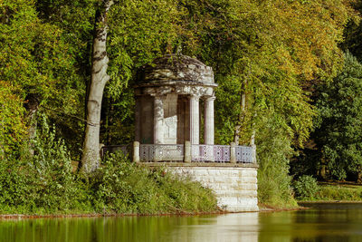 Gazebo surrounded with trees by lake