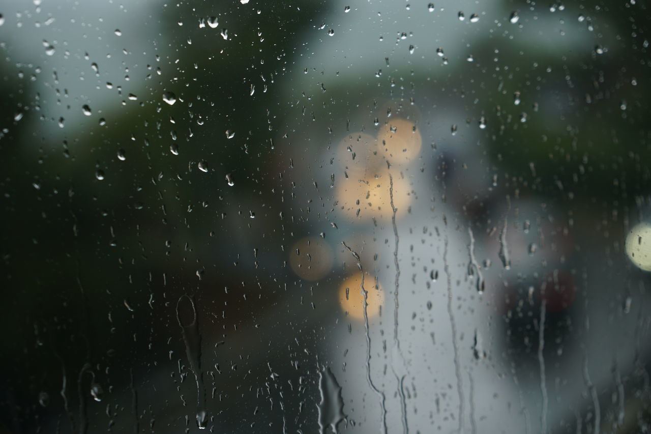 FULL FRAME SHOT OF RAINDROPS ON GLASS WINDOW