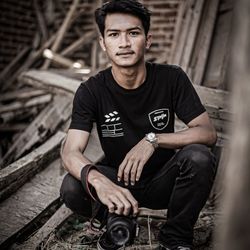 Portrait of young man sitting outdoors