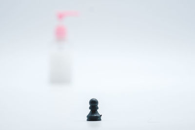 Close-up of chess pieces against white background