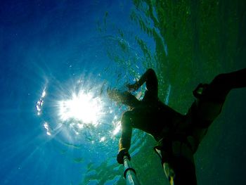 Low angle view of man swimming undersea