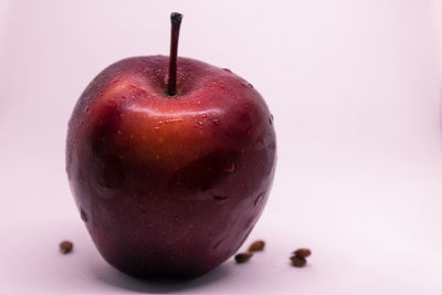 Close-up of wet apple against white background